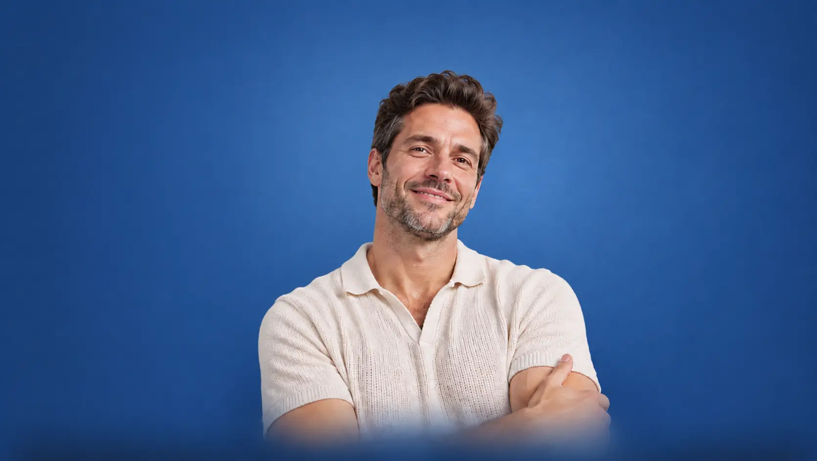 Man in a cream shirt against a blue background